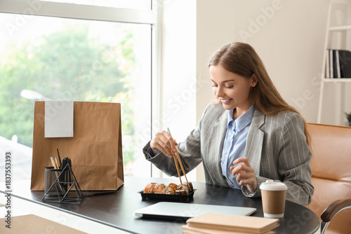 Happy young woman eating su...