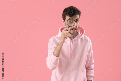 Young man with magnifier on...