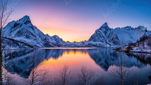 Stunning winter landscape with snow-capped mountains and a tranquil lake at sunset