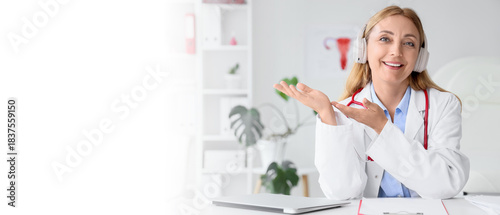 Female gynecologist with headphones giving online consultation in clinic