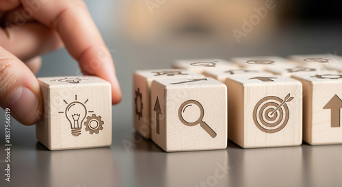 Wooden cubes featuring innovation scale icons positioned manually with controlled depth and gentle blurred background