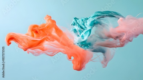 Abstract colorful ink swirling in water creates dynamic shapes against a light blue background, vivid and artistic.