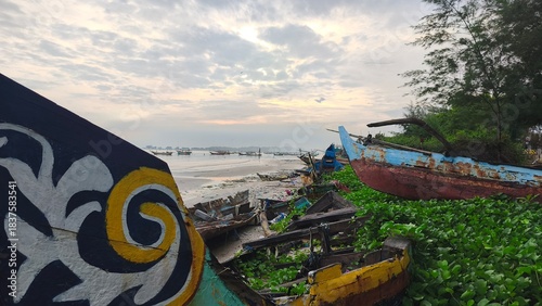 sunset atmosphere on a beach full of fishing boats