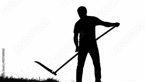 Silhouette of a man with a scythe working in a field.