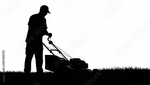 Silhouette of a man mowing a lawn with a push mower.