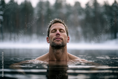 A man immerses himself in a serene mountain lake . Nature and tranquility blend beautifully in this captivating scene.