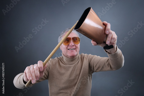 1970's retro man musician ready to play the cowbell