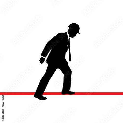 Silhouette of a businessman in a hard hat at the starting line.