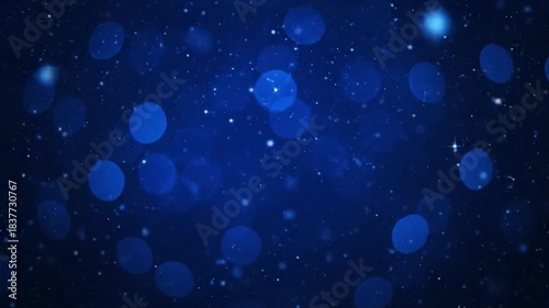 A dark blue image with blurry, circular highlights and tiny white flecks, conveying a sense of night