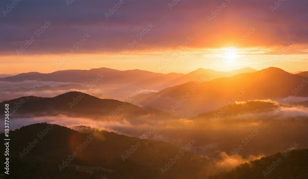 Obraz premium Golden Sunset Over Majestic Mountain Layers With Soft Misty Horizon