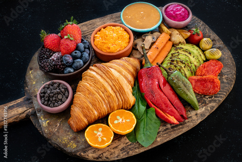 Croissant sandwich filled with ham, bacon, cheese and salad.  crowich