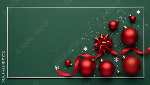 Festive red christmas ornaments and bow on dark green background