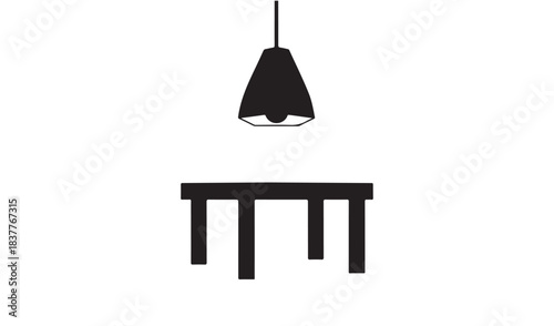 Minimalist black pendant light hanging above a simple black table