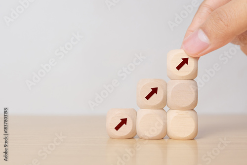 Business performance growth concept. Wooden cube stairs with increasing arrow icons on grey background. Goals, vision, plan, action for business development. Growth,high performance banner