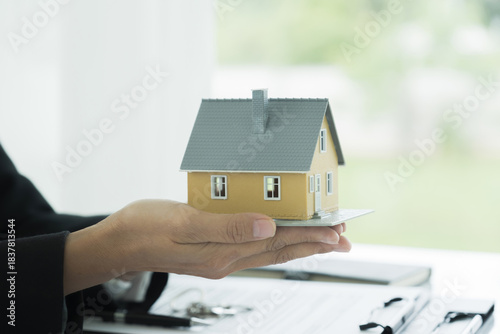 Wallpaper Mural Real estate agent handing house model Torontodigital.ca