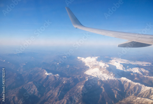 Caucasus mountains with snow peaks in aerial winter scene. Aerial view from plane.