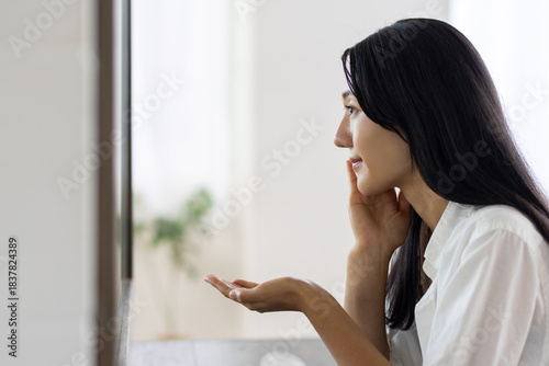 Woman Applying Lotion in Front of Mirror Free Download Woman Applying Lotion in Front of Mirror - GFXLoad