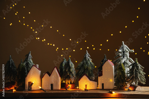 Tiny houses with glowing windows. Festive Christmas atmosphere.
