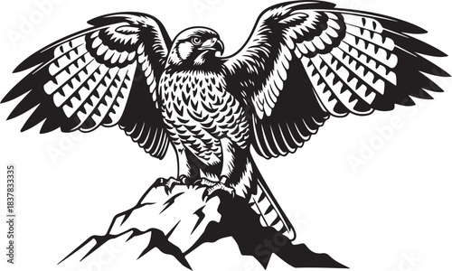 Black silhouette of a falcon perched on a rock with wings spread