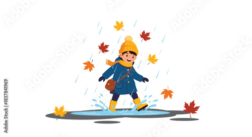 Happy child in a yellow hat and blue coat splashing in a puddle during a rainy autumn day with colorful falling leaves.