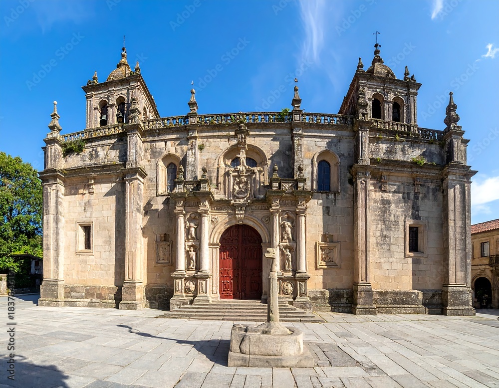 Fototapeta premium Large, classic stone building with ornate carvings, red door