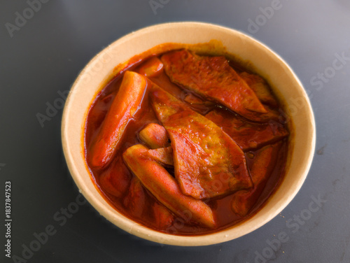Tableau sur toile Delicious Toppoki with Spicy Red Sauce in Classic White Bowl