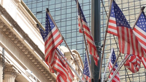 American flags near Grand Central Terminal on 42 street, New York City, Manhattan Midtown. Railway building architecture in United States. Public railroad transport junction. Old station exterior.