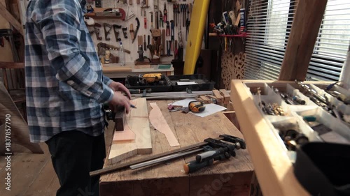 A carpenter in a garden furniture workshop