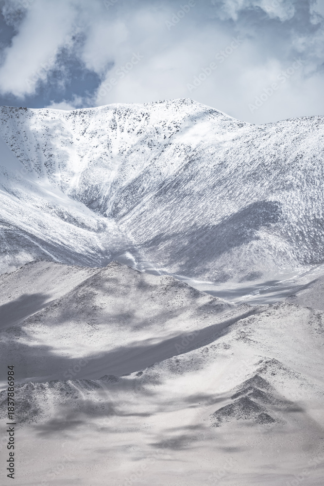 Fototapeta premium Landscape in the Pamir Mountains of Tajikistan with snow, glaciers, and cliffs, a panorama of mountains in cloudy weather for the background, nature in the Tien Shan highlands, landscape background
