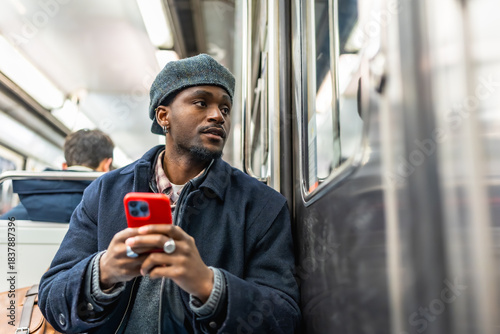 Young man commuting on subway looking out window
