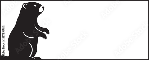 Black silhouette of a groundhog standing upright in a rectangle frame