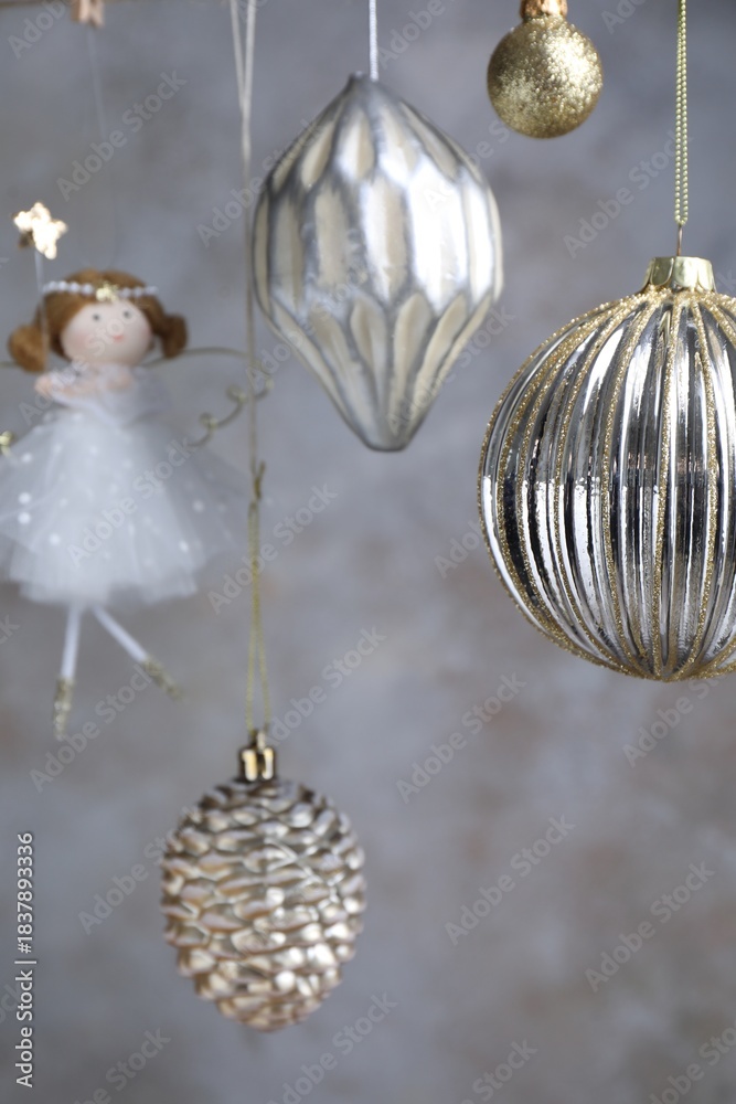 Obraz premium Beautiful Christmas decor hanging near light grey wall, closeup