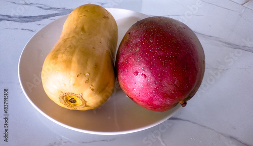Butternut squash and red mango in white bowl
