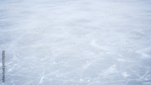 Frozen expanse: A textured ice surface with visible skate marks and patterns