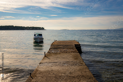 concrete pier and boat, late afternoon, adriatic sea, croatia, mediterranean