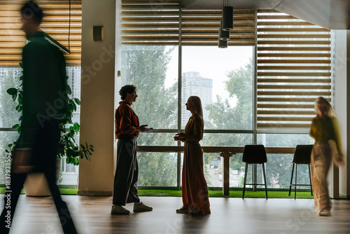 Colleagues having a discussion in a modern office interior