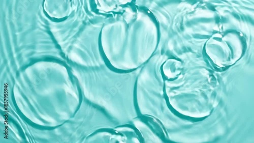 Water droplets in pool close up of small water droplets creating ripples on surface of still pool