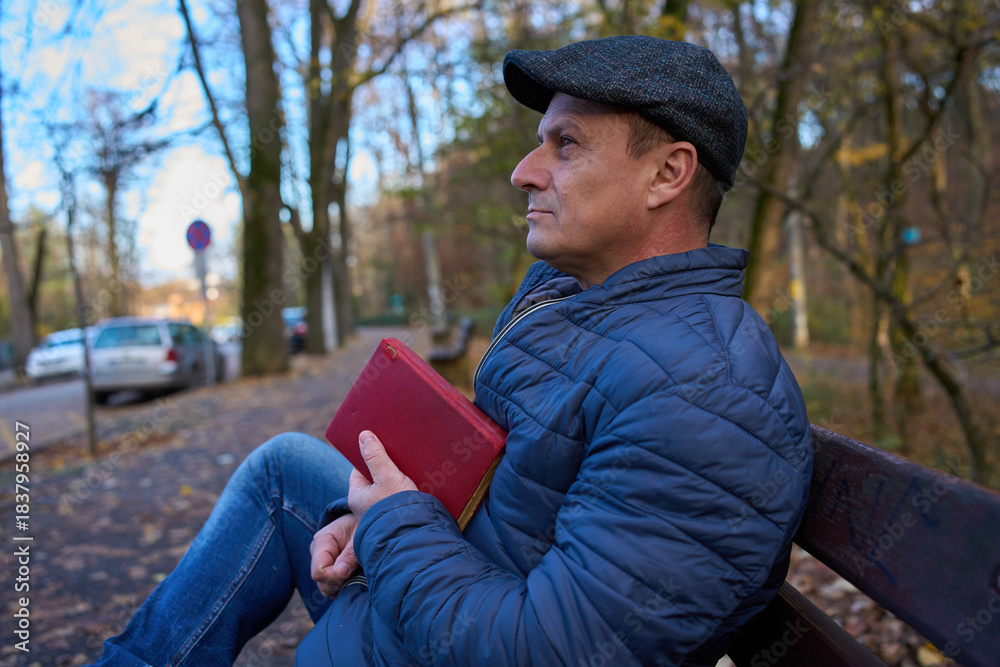 Fototapeta premium Man in thoughtful moment with book
