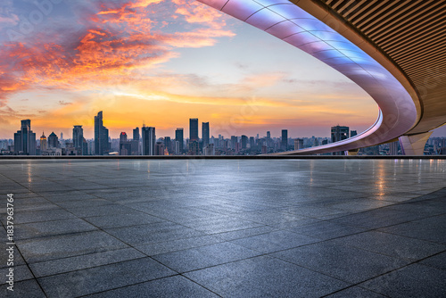 Empty square floor and city skyline with modern commercial buildings at sunset in Shanghai