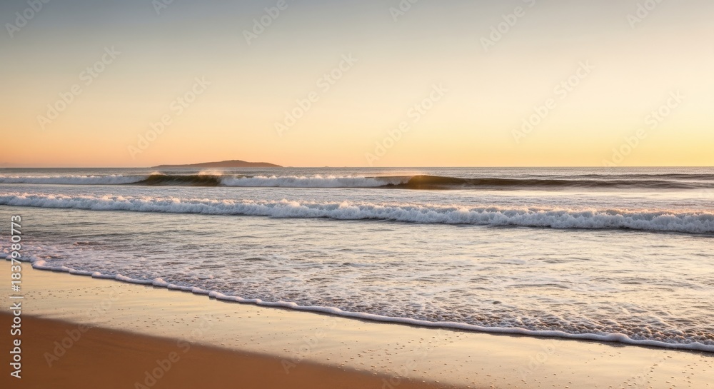 Obraz premium Golden Hour at the Coastline: Serene Beach Scenery with Gentle Waves and Warm Light
