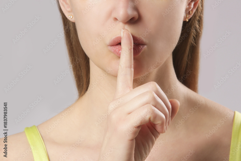 Fototapeta premium Finger on lips - silent gesture 