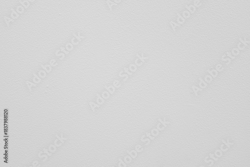 A white wall with a cement and concrete surface for placement and as a background. The cement wall has space for text.