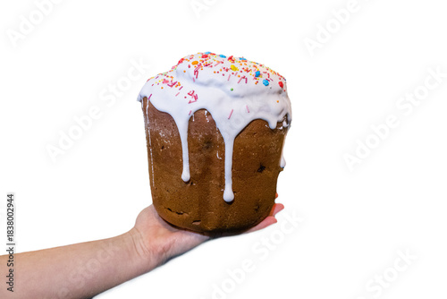 Classic Easter Kulich Pastry with Sweet Glaze and Colorful Toppings on Hand