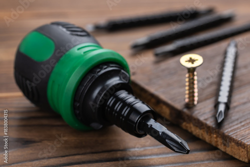 Wallpaper Mural screwdriver and screws on wooden background close up Torontodigital.ca