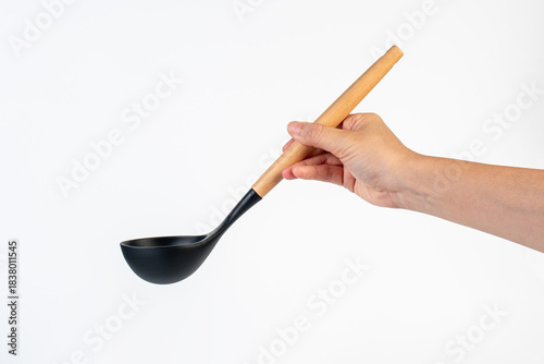 Black plastic spatula in hand on white background