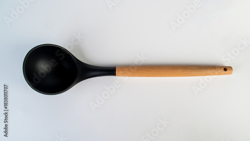 Black plastic spatula in hand on white background