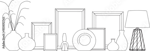Line art arrangement of various vases picture frames and a table lamp home decor interior