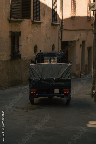 antique truck scene, historic cargo vehicle set against twilight shadows and textured urban surroundings