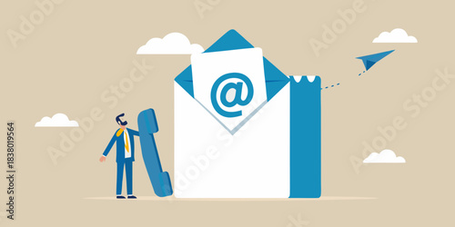 A businessman looks at a giant email with an at symbol and paper airplane