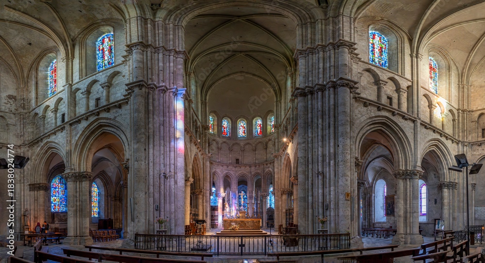 Fototapeta premium Blois, France - 10 26 2025: Saint Nicholas Church. Panoramic view of the transept with stained glass windows and altar at the back